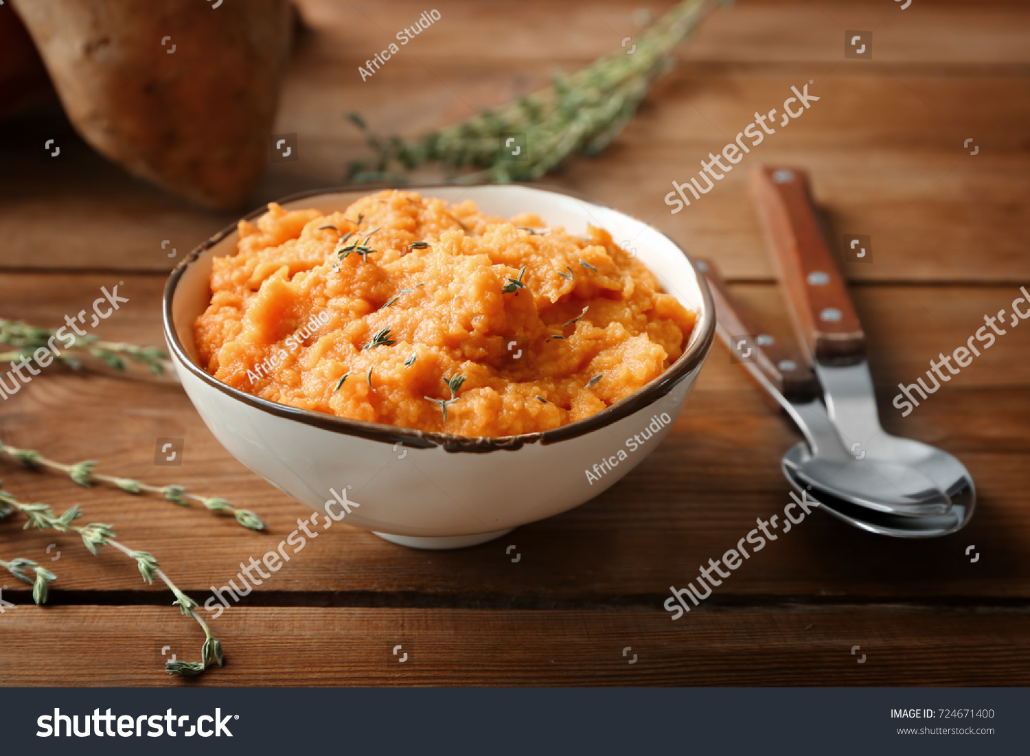 Bowl with mashed sweet potato on wooden background #724671400