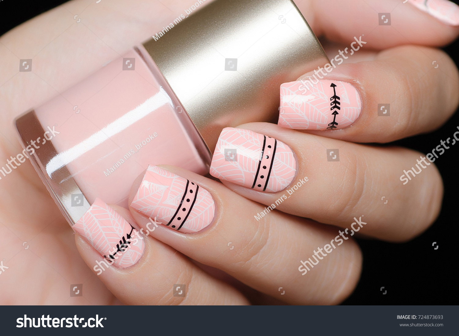 pink manicure with tropical leaves and a geometric pattern #724873693