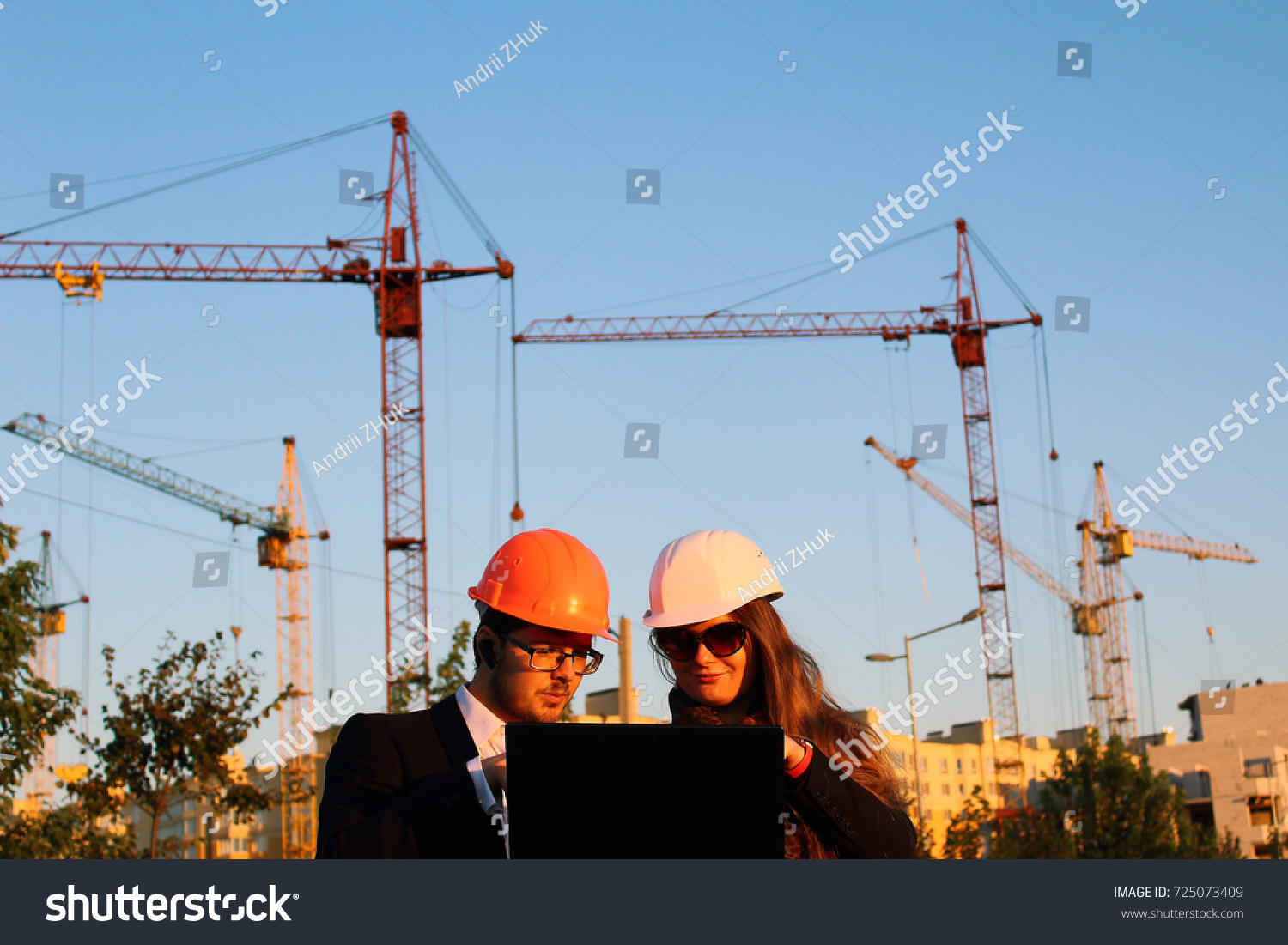 male and female in the helmets on the background of the building #725073409