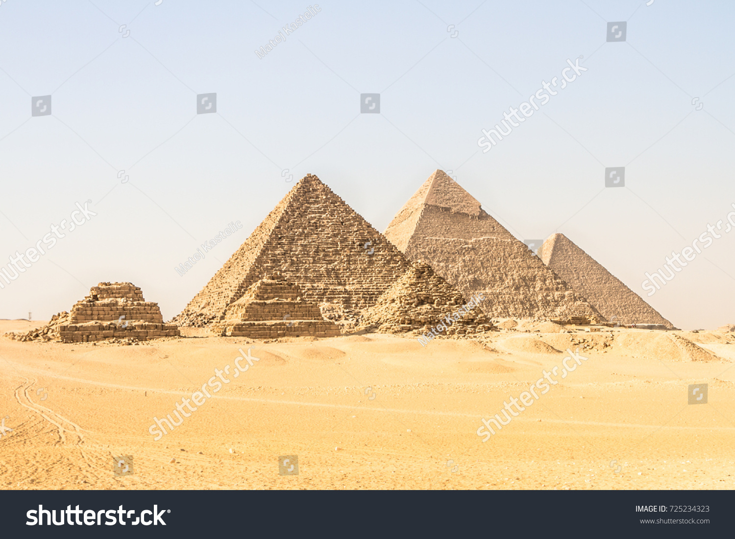Giza pyramids in Cairo, Egypt. General view of pyramids from the Giza Plateau Three pyramids known as Queens' Pyramids on front side. Next in order from left, the Pyramid of Menkaure, Khafre and Chufu #725234323