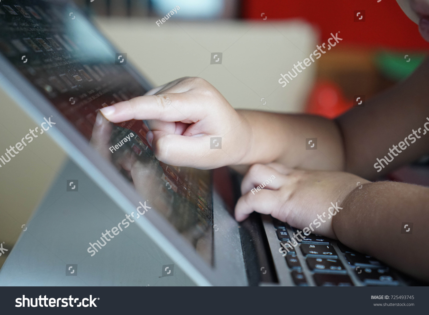 Baby asian toddler girl working on computer, notebook, laptop and point to screen monitor #725493745