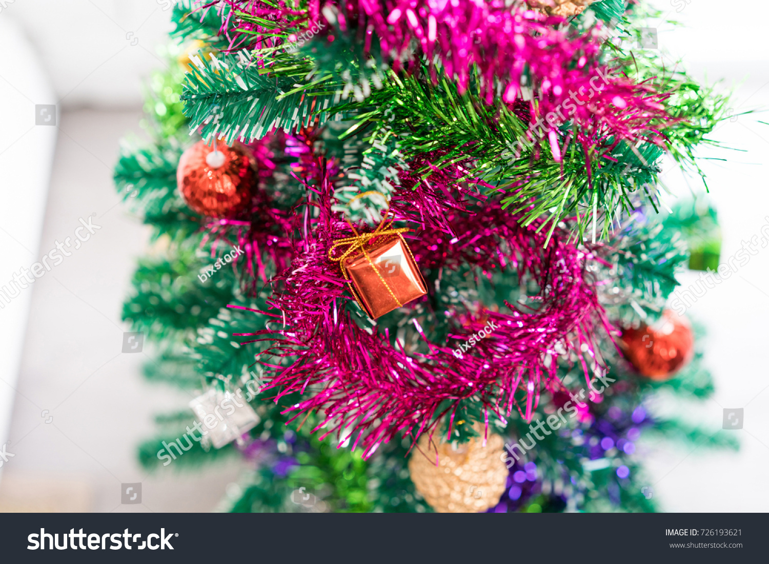 Close-up christmas tree with red bauble hanging from a decorated and light bokeh. concept of merry christmas and happy new year. Xmas background. #726193621
