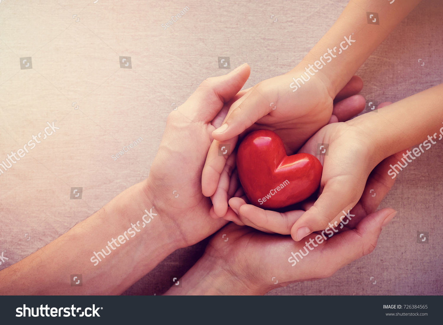 adult and child hands holding red heart, health care love, give, hope and family concept, world heart day,world health day #726384565