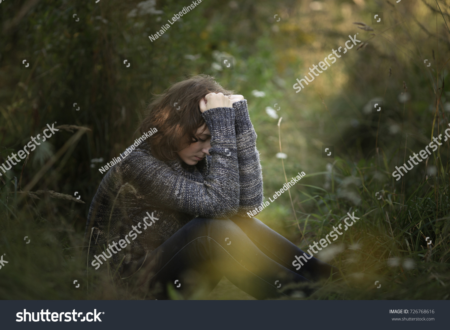 head on hands, beautiful brunette woman yearns and sadness outdoors, concept depressed and lonely, dark style in nature #726768616