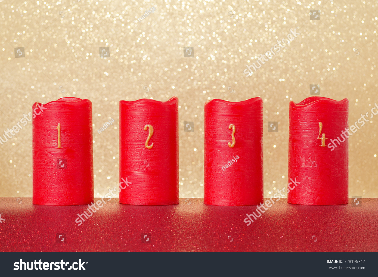 traditional advent candles with numbers and gold background, copy space #728196742