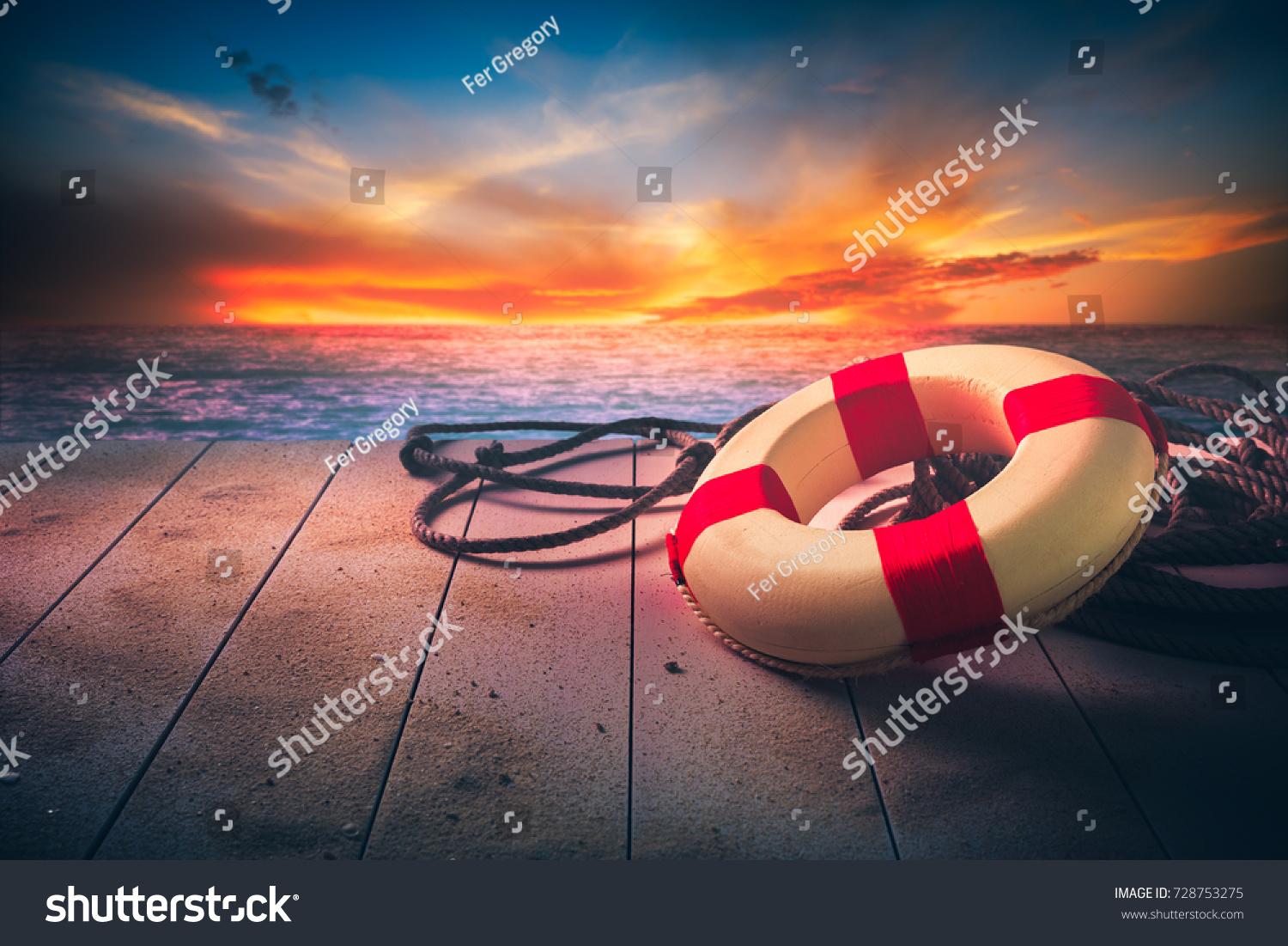 life saver on a dock at the beach on a sunny day #728753275