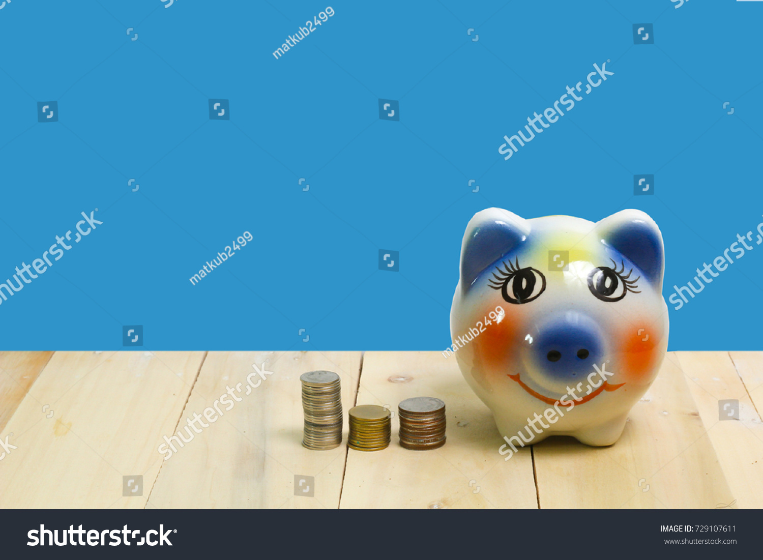piggy bank and on wood blue background #729107611