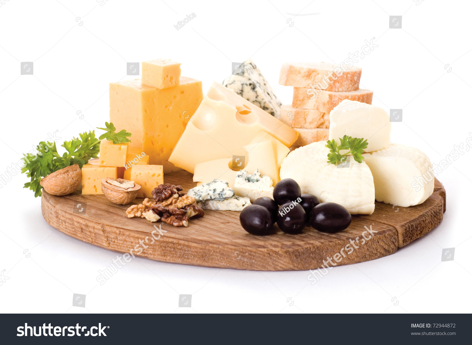 cheese board with delicous cheeses, walnuts and black olives #72944872