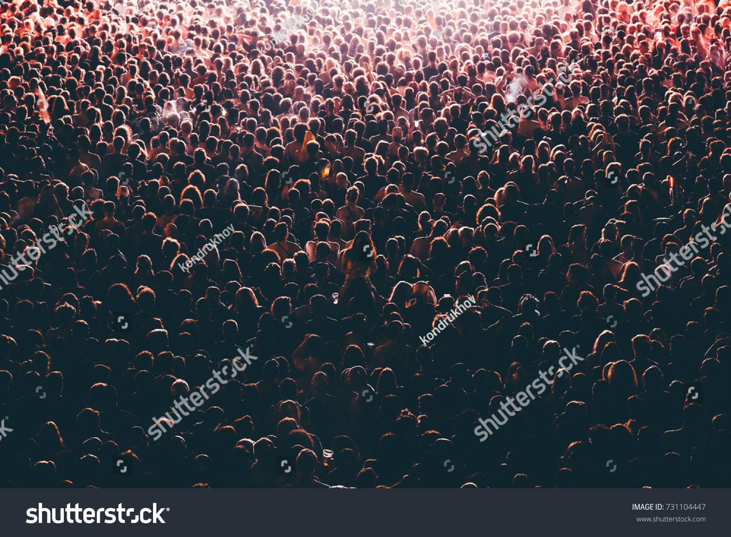 Colorful crowd of people of a big music festival in a stage lights as a beautiful background #731104447