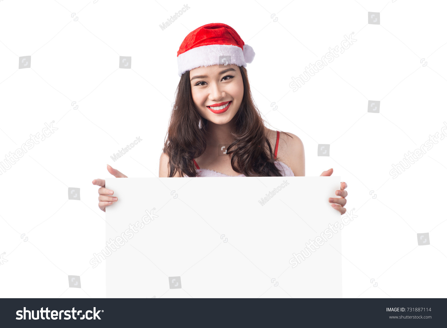 Asian Christmas girl with Santa Claus clothes holding blank sign isolated on white background #731887114