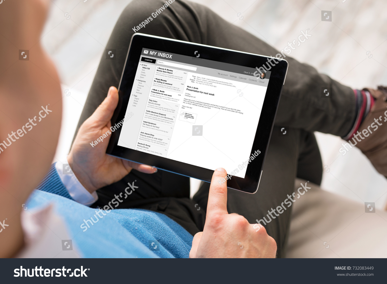Man reading email on tablet. All content is made up. #732083449