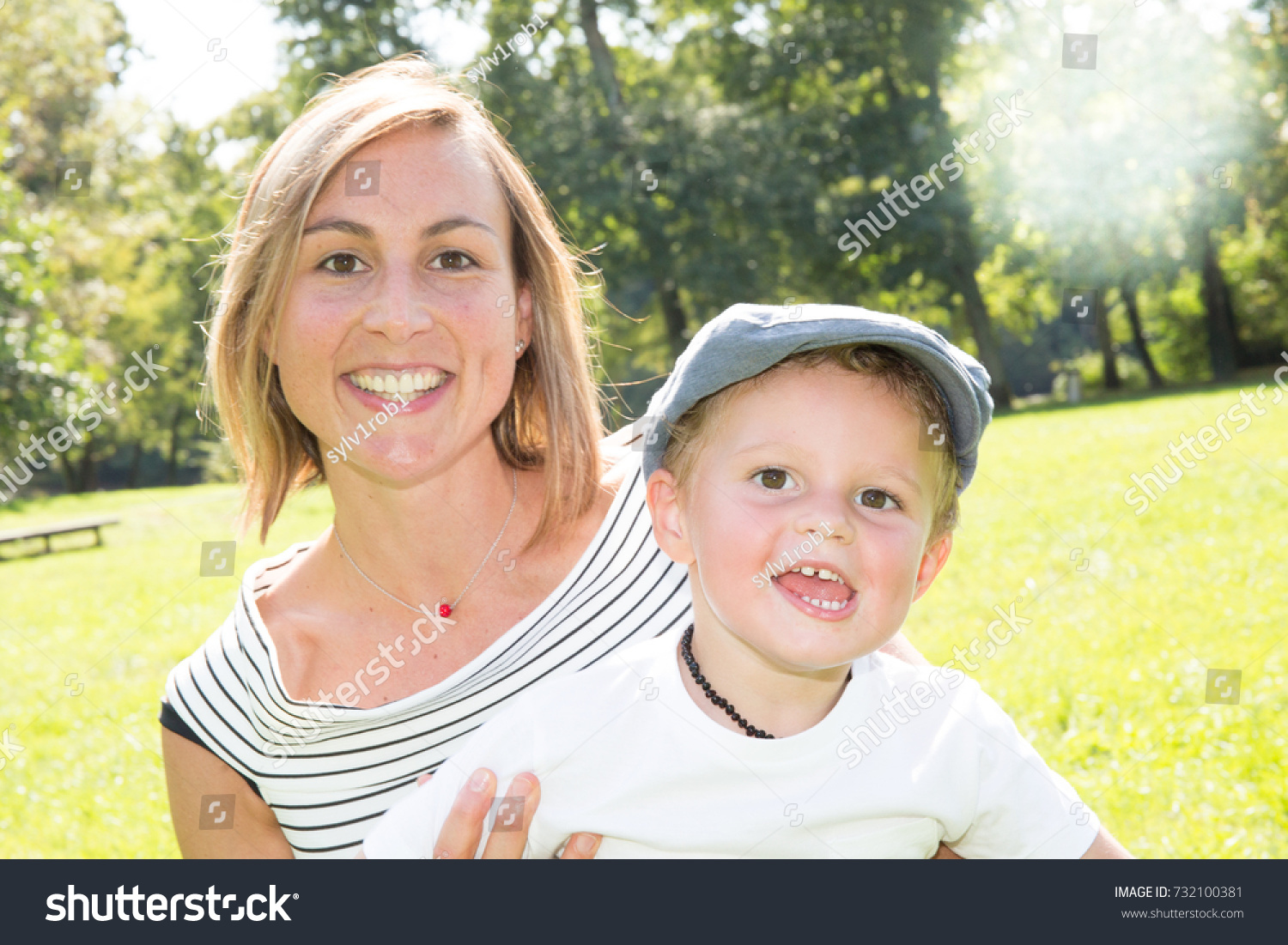 lovely family mother and little son in green grass home garden at house #732100381