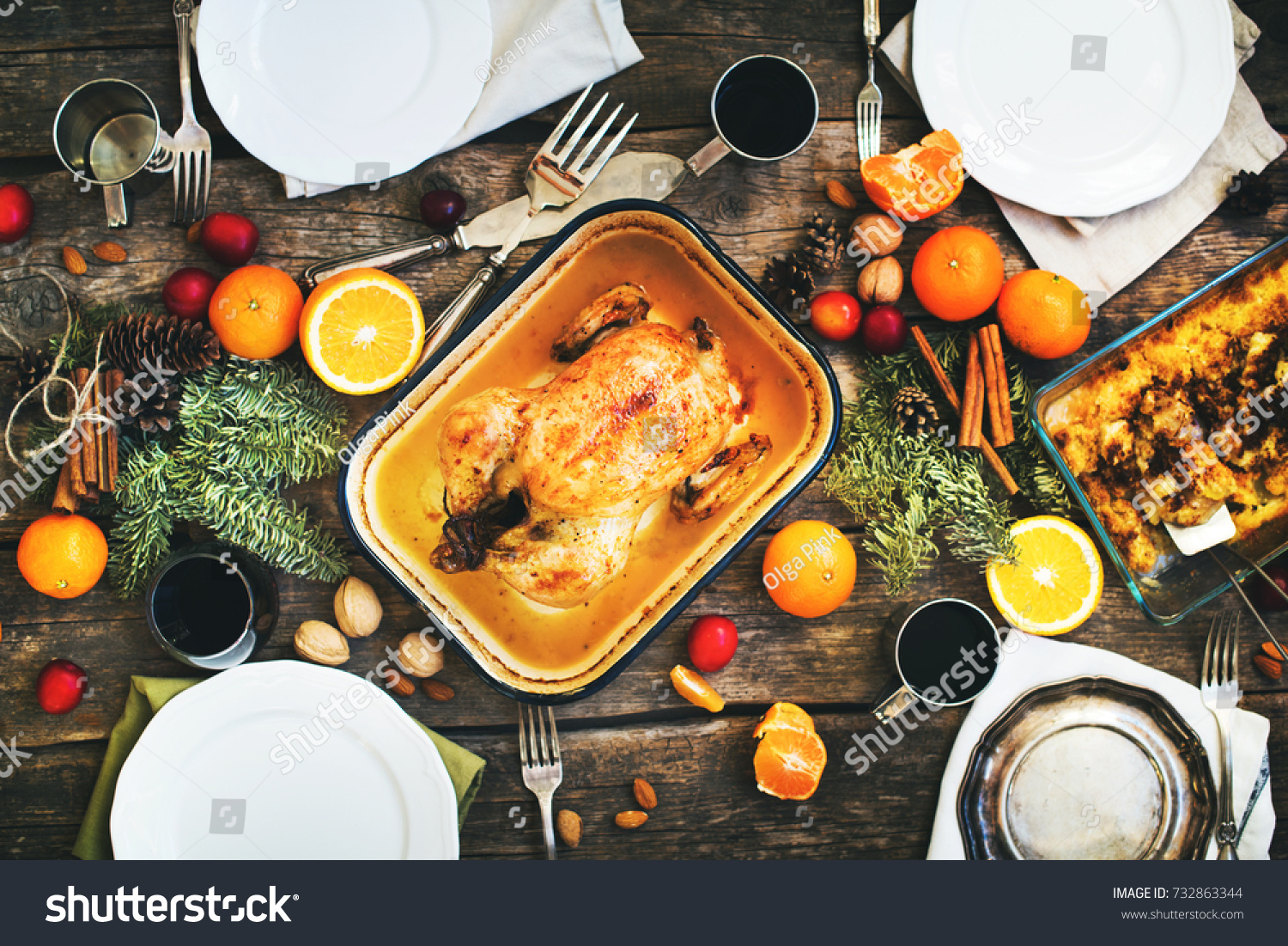 Baked Whole Chicken for Christmas or Thanksgiving Day Table with Fruits Seasonal Spices Metal Pallet Wooden Table Top View Main Course #732863344