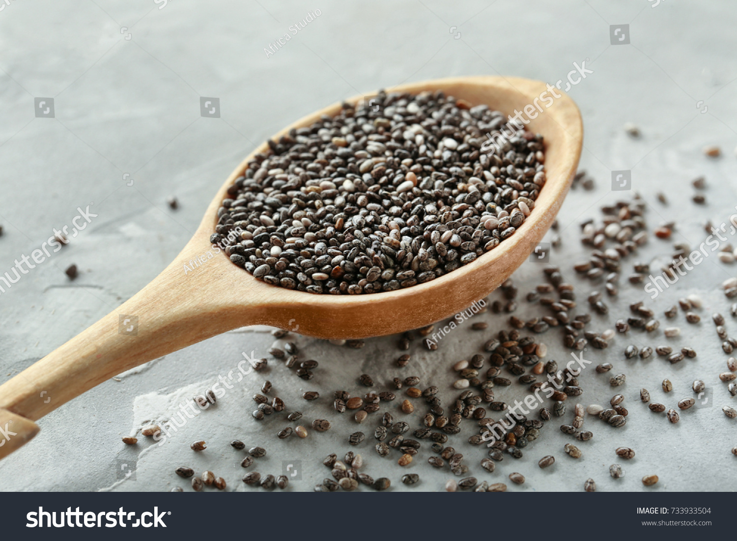 Spoon with chia seeds on table #733933504