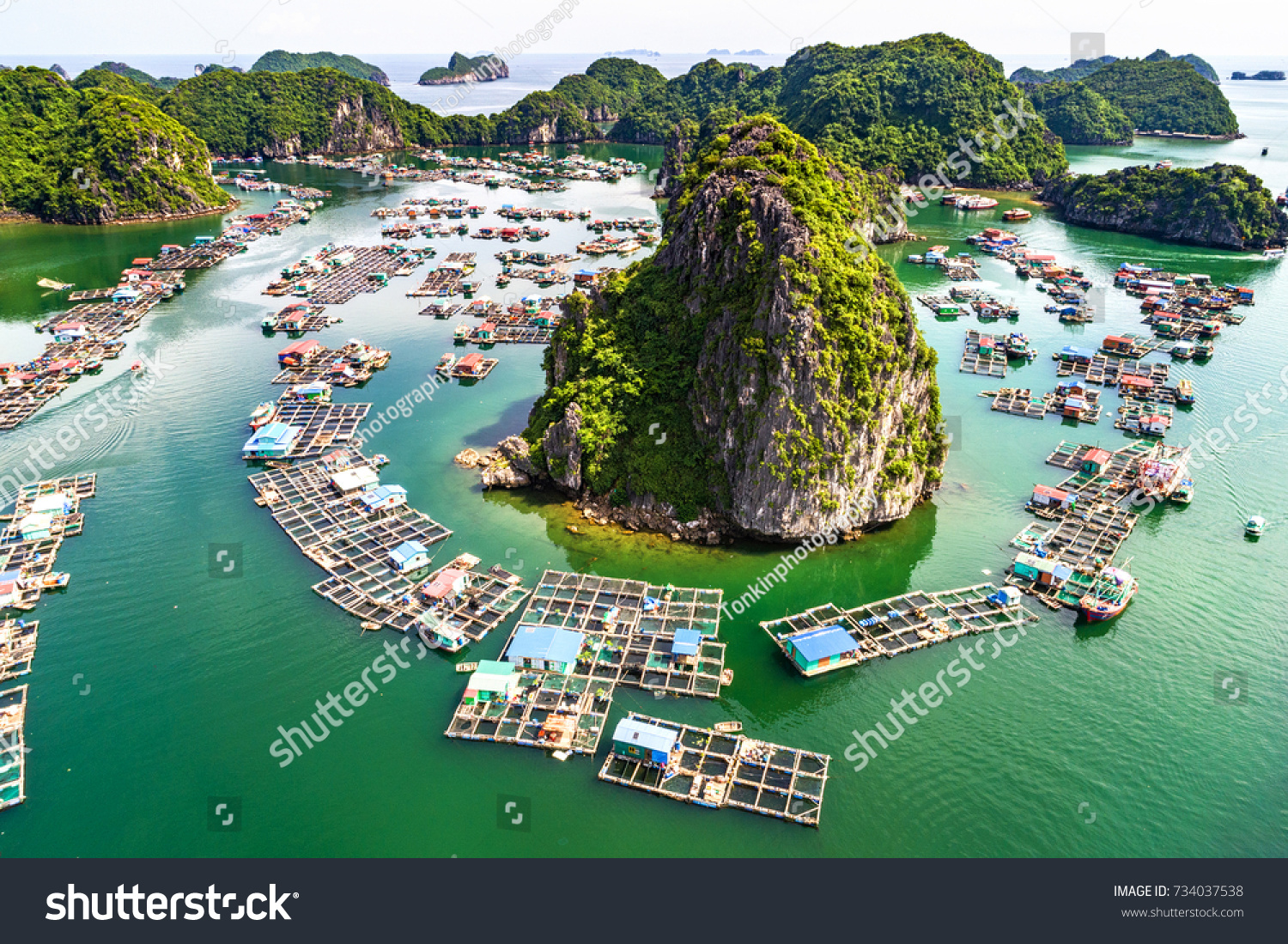 Floating fishing village and rock island in " Lan Ha " Bay, Vietnam, Southeast Asia. UNESCO World Heritage Site. Landscape. Popular landmark, famous destination of Vietnam. Near " Ha Long " bay #734037538