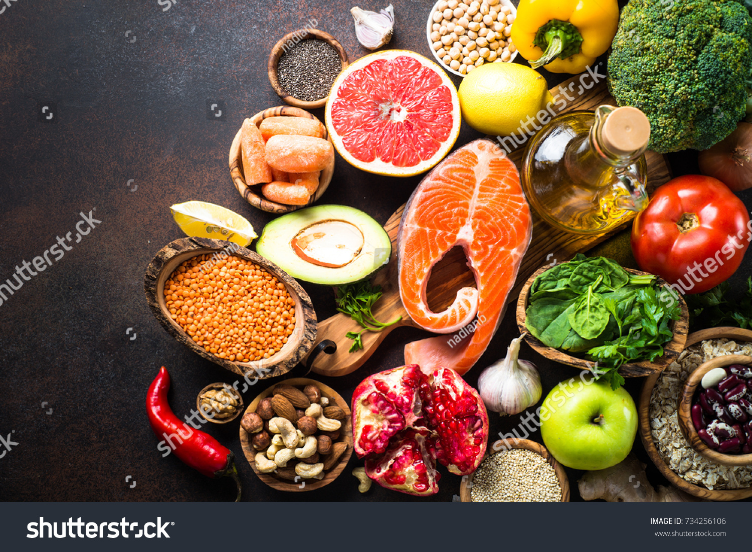 Balanced diet food background. Organic food for healthy nutrition, superfoods. Meat, fish, legumes,  nuts, seeds, greens, oil and vegetables. Top view copy space on dark stone table. #734256106