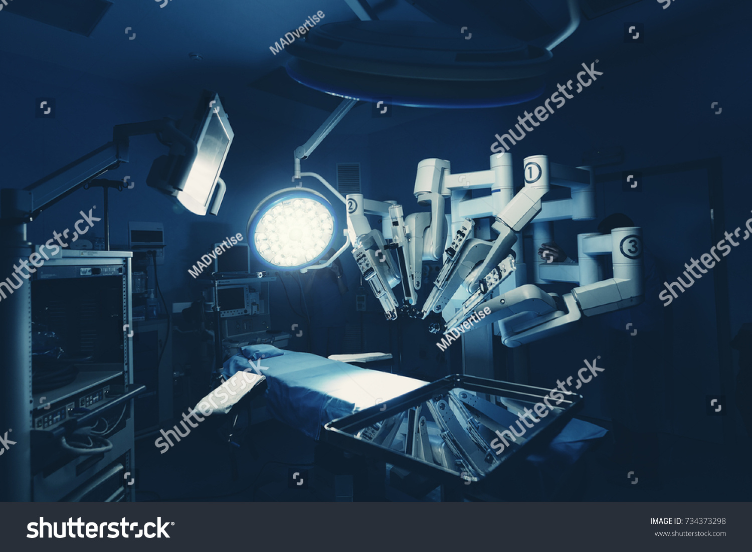 Surgical room in hospital with robotic technology equipment, machine arm surgeon in futuristic operation room. Minimal invasive surgical inoovation, medical robot surgery with 3D view endoscopy #734373298