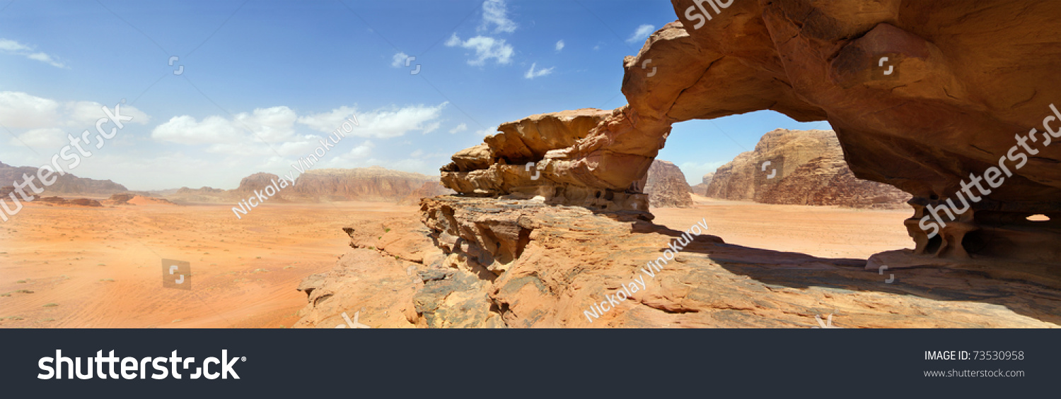 natural rock bridge and panoramic view of Wadi Rum desert, Jordan #73530958