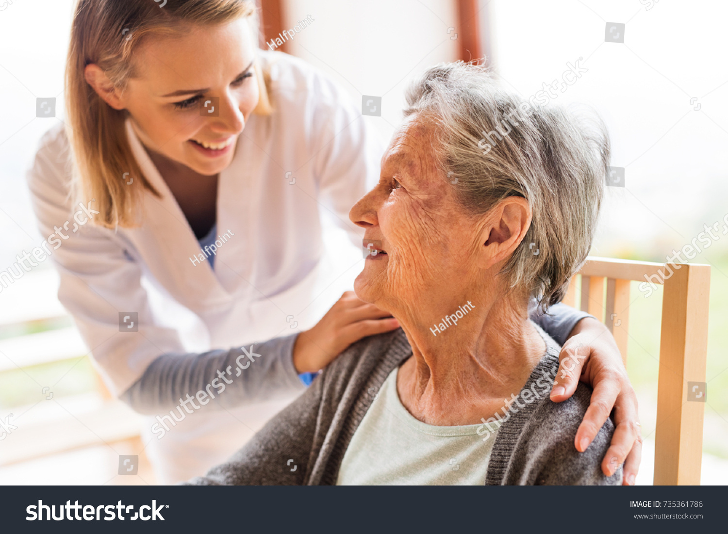 Health visitor and a senior woman during home visit. #735361786