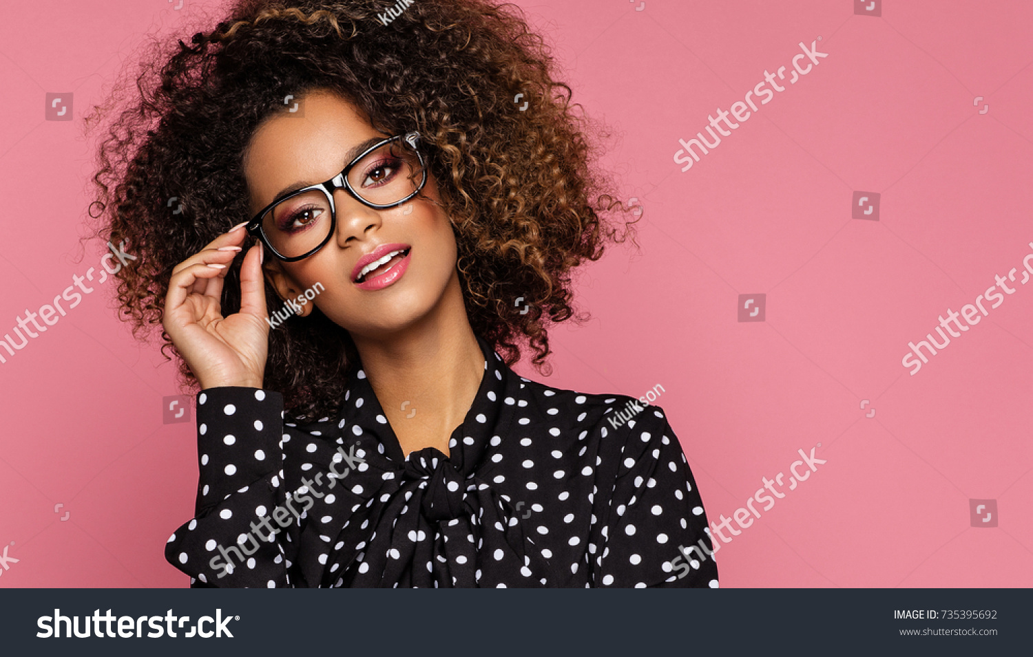 Beautiful black woman model wear black shirt in peas and holding glasses  #735395692
