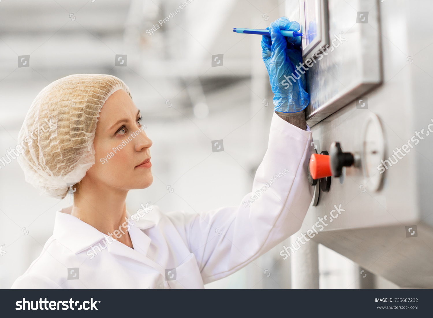 manufacture, industry, production and people concept - woman programming industrial equipment with computer at ice cream factory #735687232