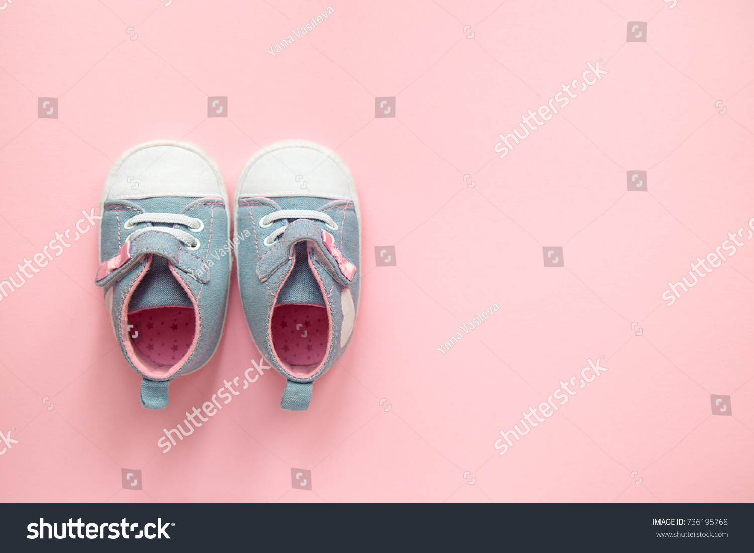 Children's denim sports shoes for girls, stands on a pink background. closeup view from the top. the concept of children's clothing. #736195768