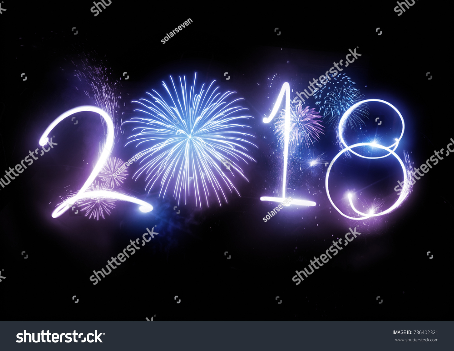 The year 2018 displayed with fireworks and strobes. New year and holidays concept. #736402321