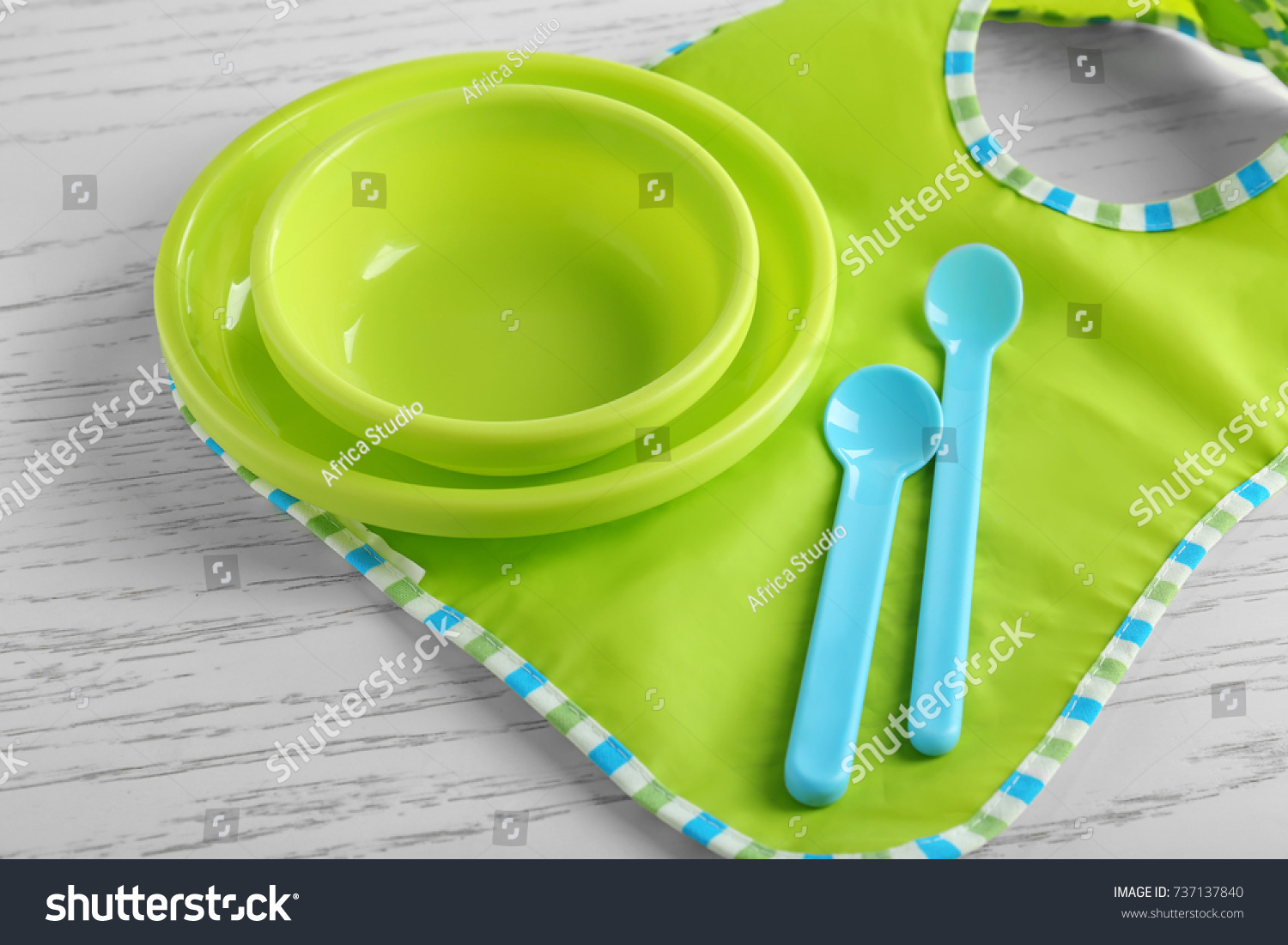 Set with bright baby dishware on table #737137840