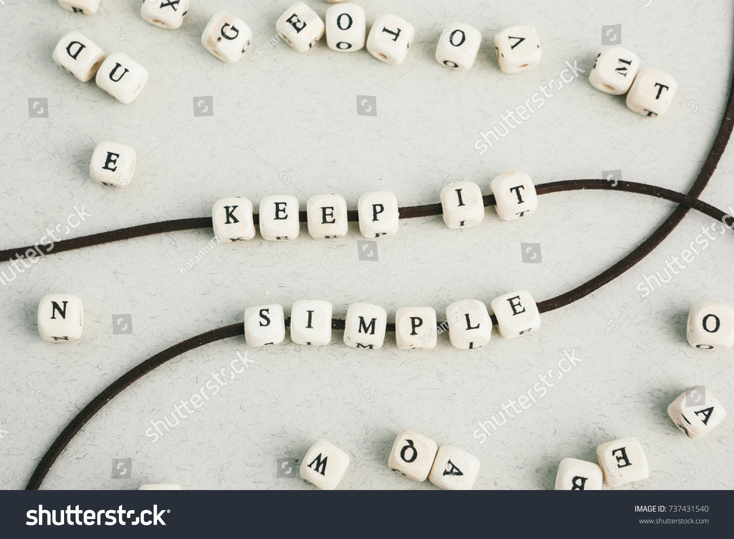 Motivation phrase Time is now from wooden beads strung on leather cord. Vertical composition. a series of photos with words and phrases #737431540