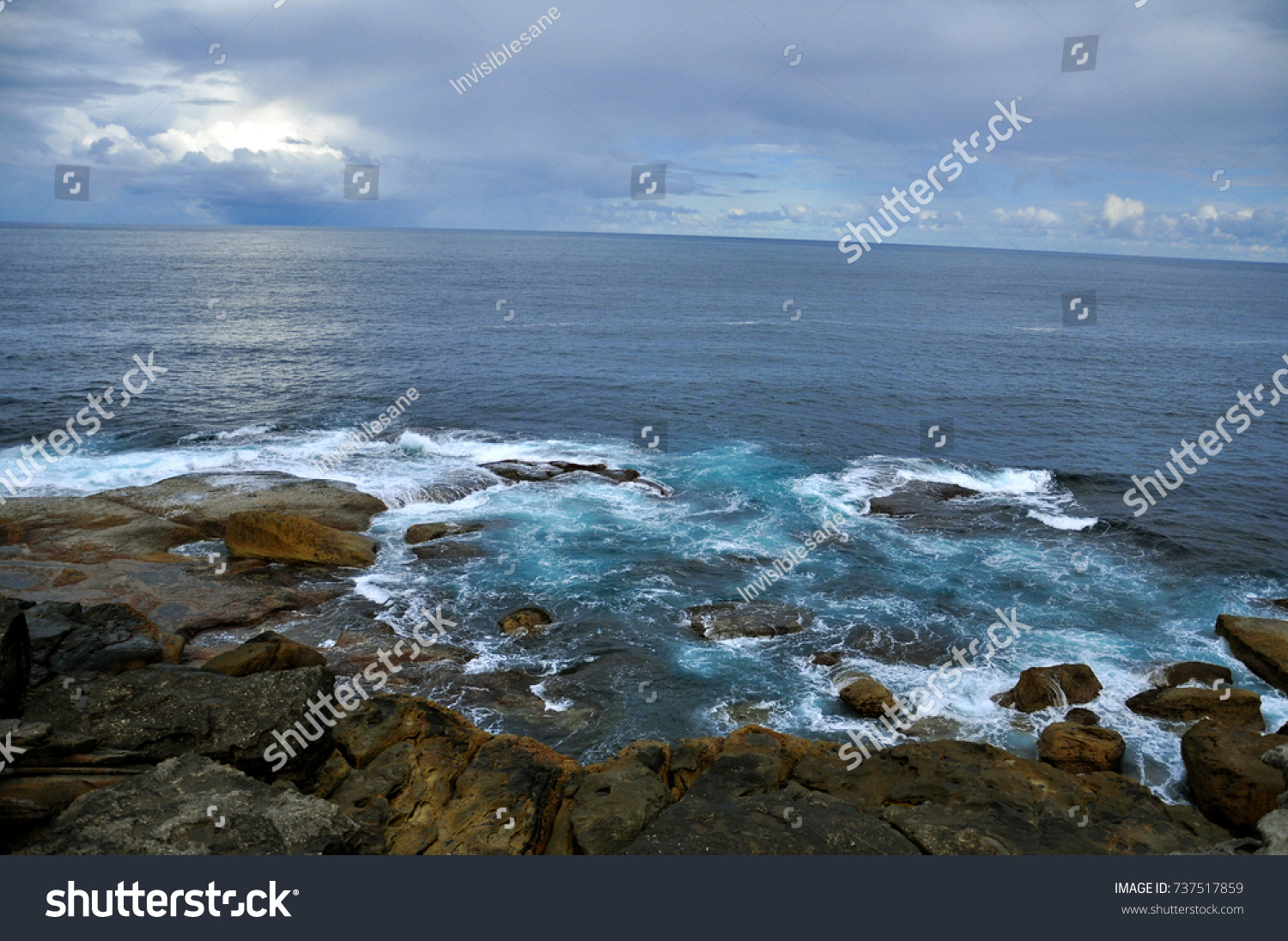 Ocean wave with rocks at Bondi Beach, Sydney, Australia #737517859