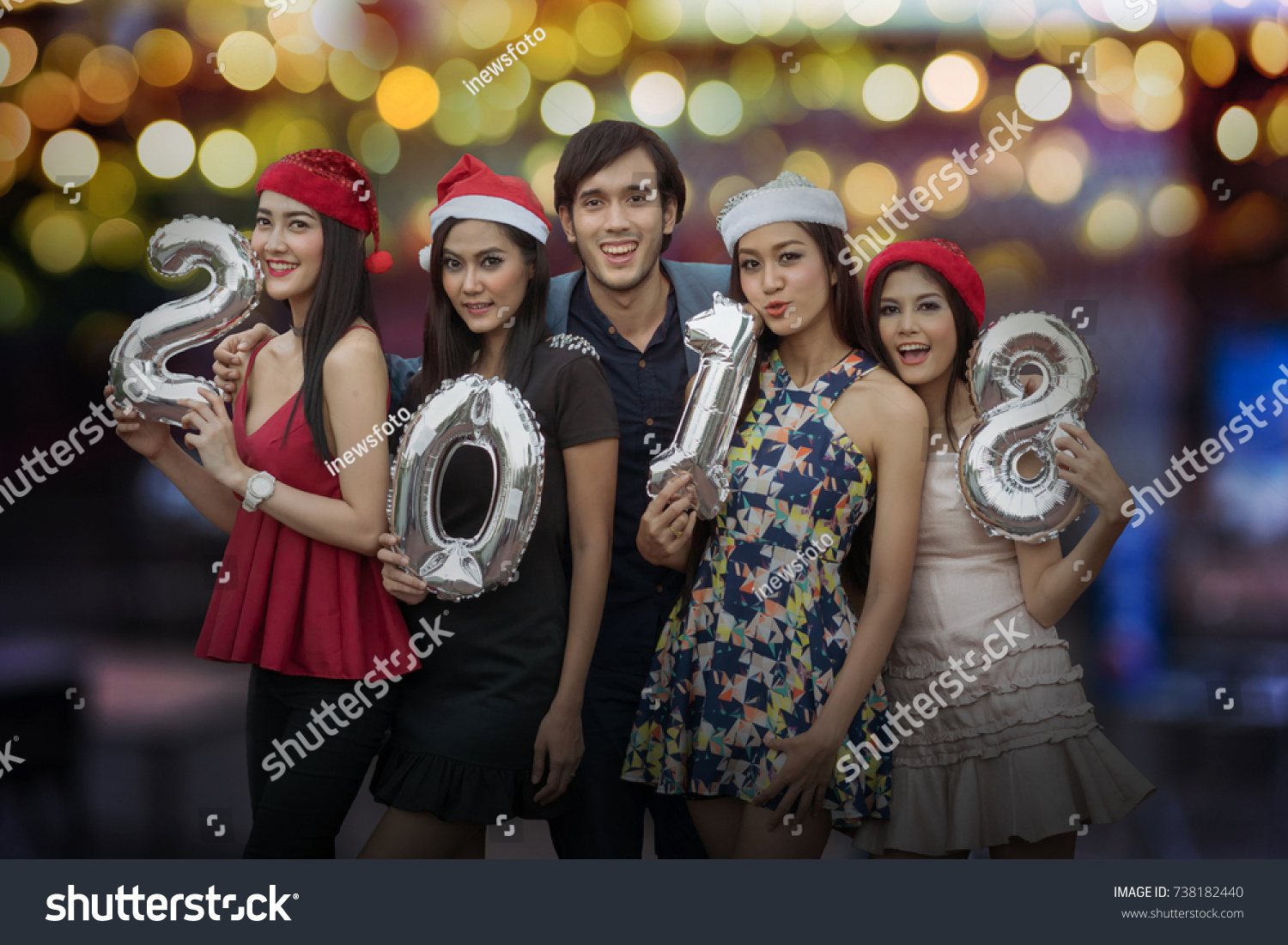Cheerful young people holding cardboard number in night party, New Year's Party 2018 concept. #738182440