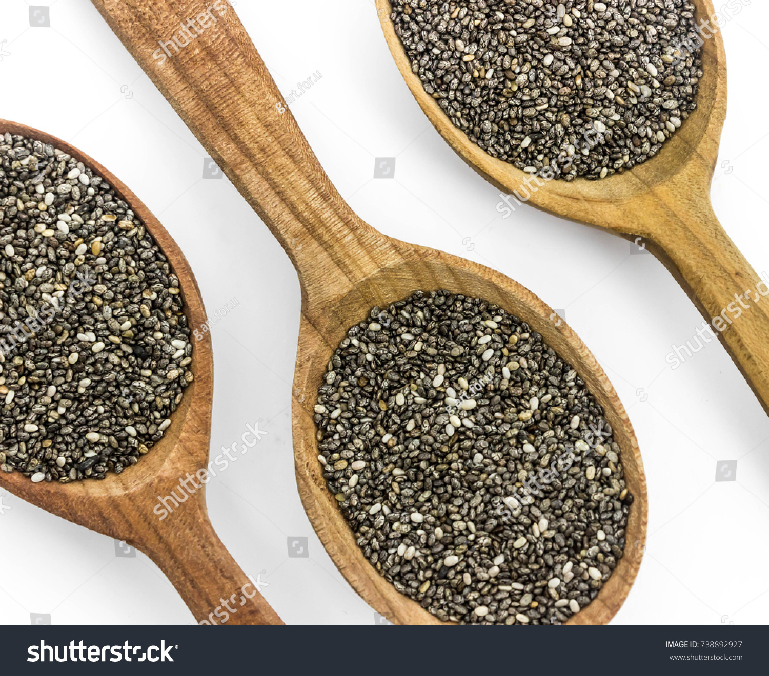 Salvia hispanica, commonly known as chia.
Three wooden spoon with chia seeds against the white background, isolated #738892927