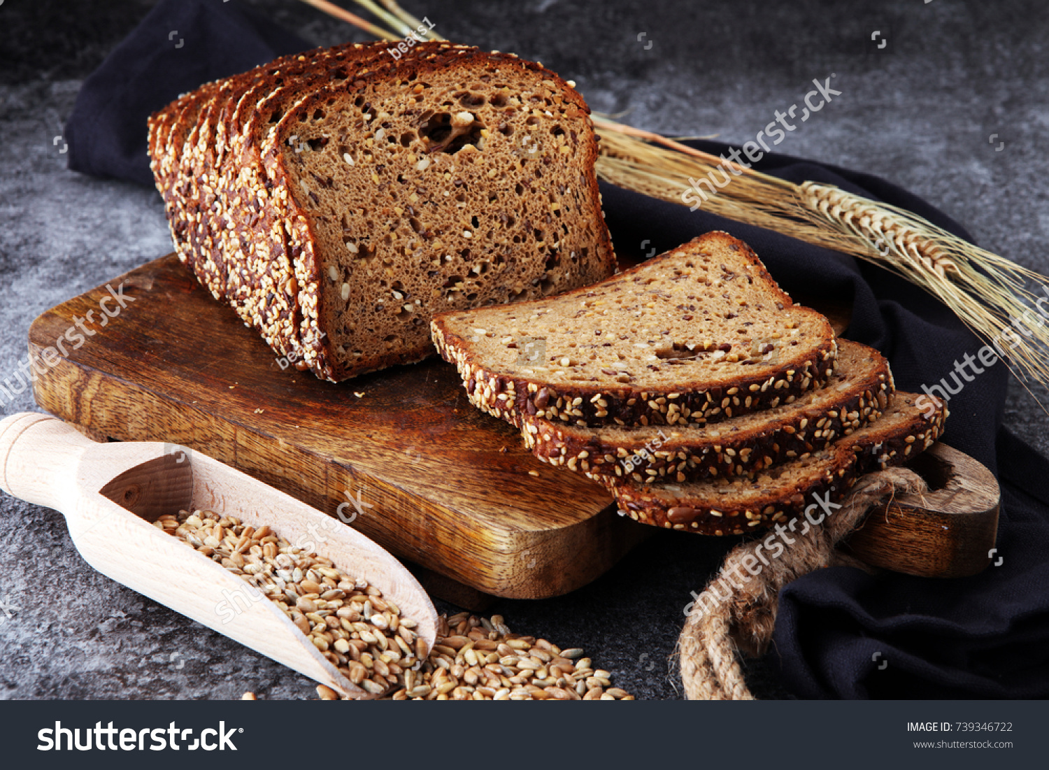 Sliced rye bread on cutting board. Whole grain rye bread with seeds #739346722