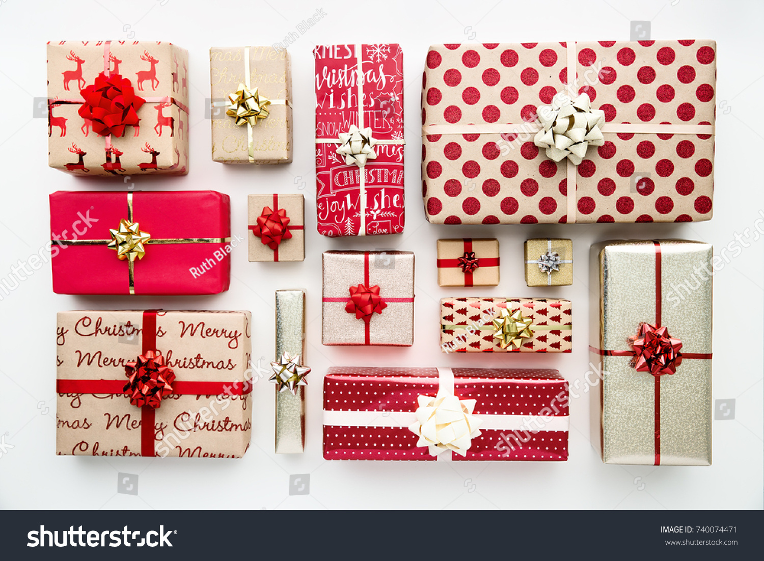 Collection of Christmas presents arranged on a white background, overhead view #740074471