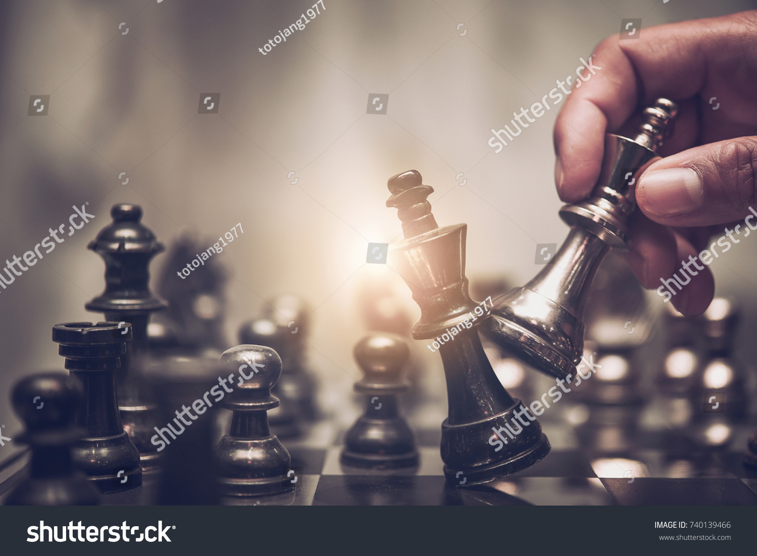hand of businessman moving chess figure in competition success play. strategy, management or leadership concept  #740139466