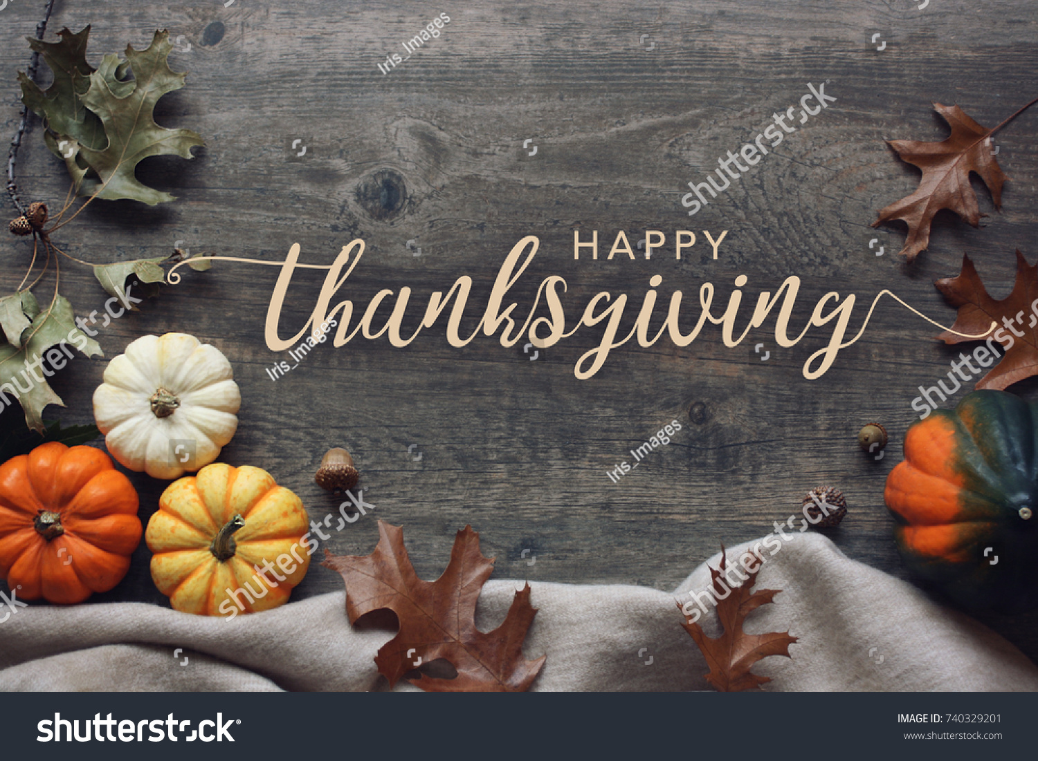 Happy Thanksgiving script with pumpkins and leaves over dark wooden background #740329201
