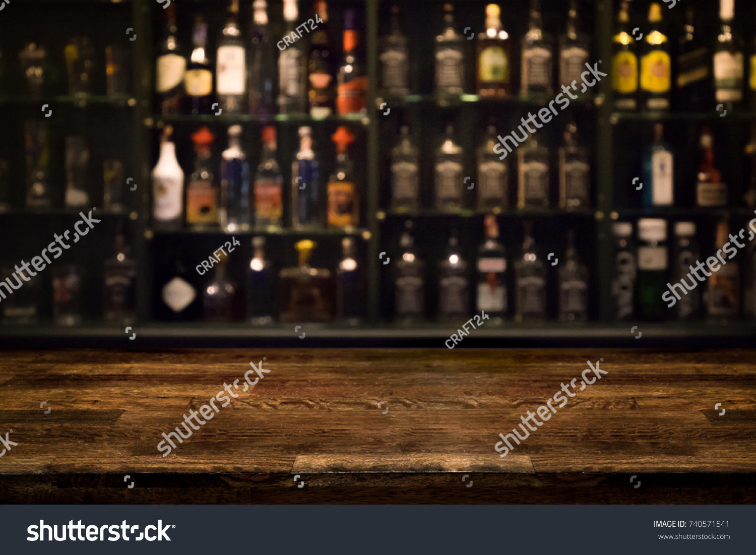 Empty wooden bar counter with defocused background and bottles of restaurant, bar or cafeteria background /for your product display #740571541