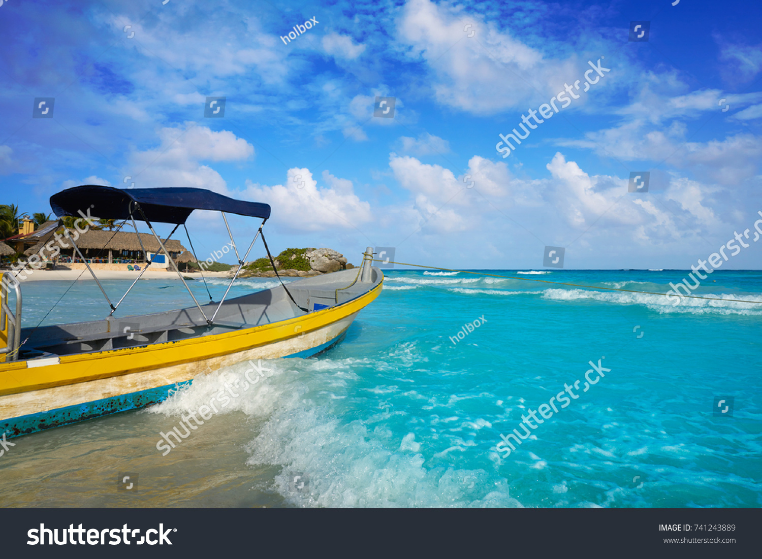 Tulum Caribbean turquoise beach boat in Riviera Maya of Mayan Mexico #741243889