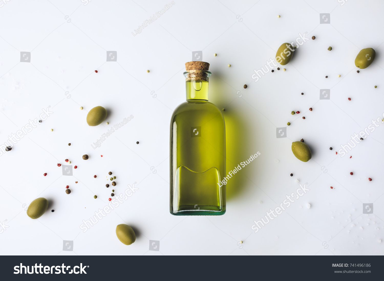 Top view of glass bottle with olive oil and olives isolated on white #741496186