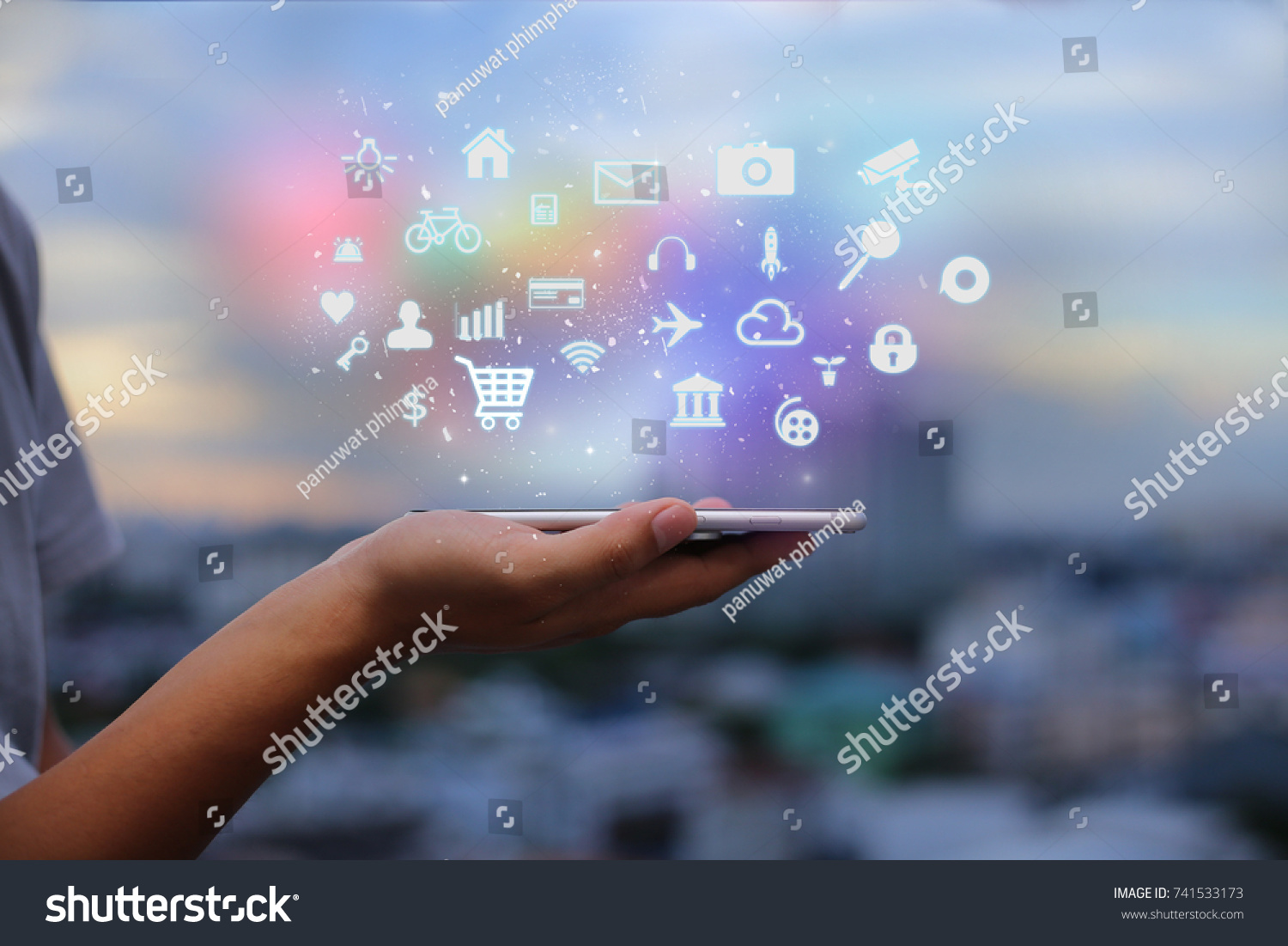 Mobile application concept.Man using touch screen smart phone on blurred urban city background #741533173