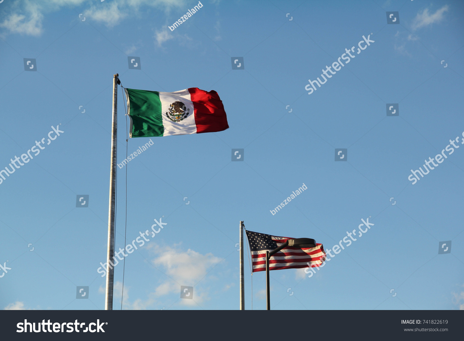 A Mexican flag and a flag of the United States of America, marking the border between Ciudad Juarez, Mexico, and El Paso, Texas #741822619