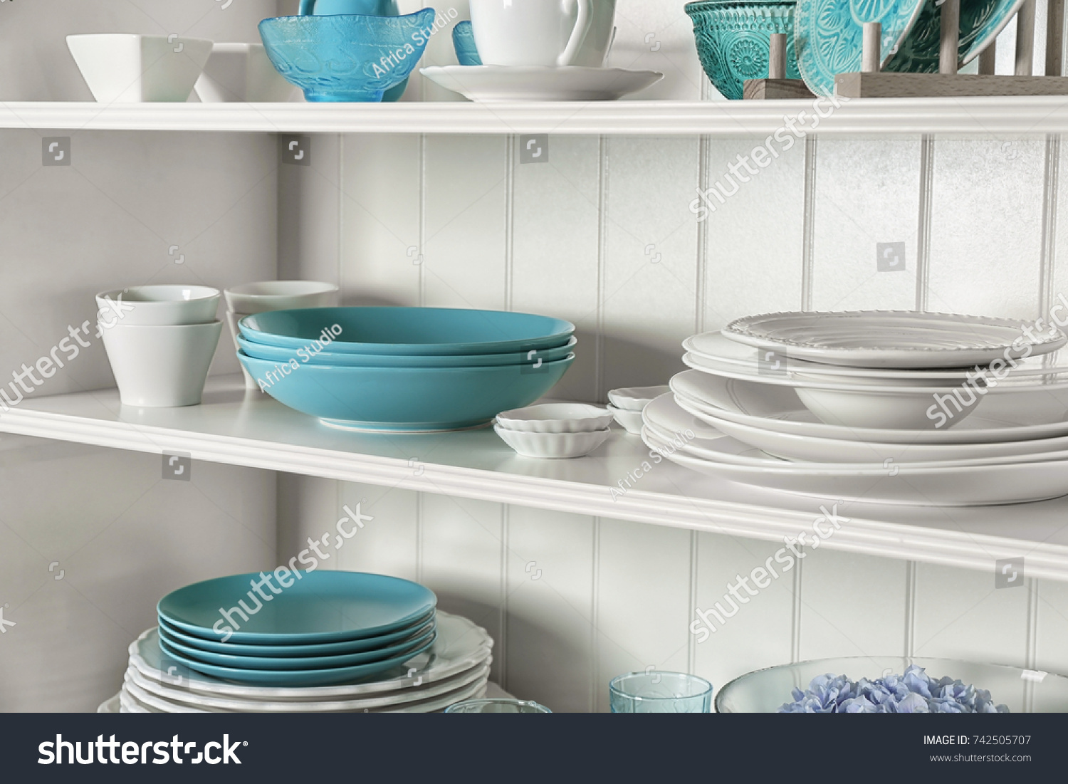 White storage stand with dishware in kitchen #742505707