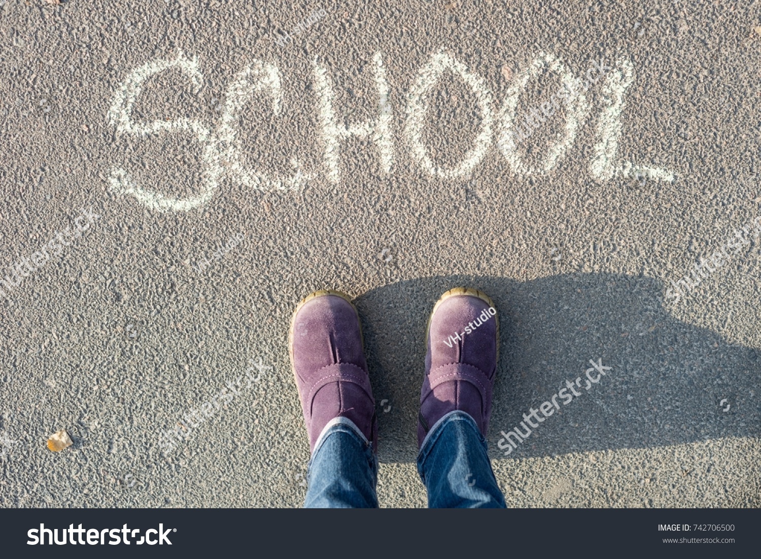 The word school on the asphalt and the feet of the student. Back to school #742706500