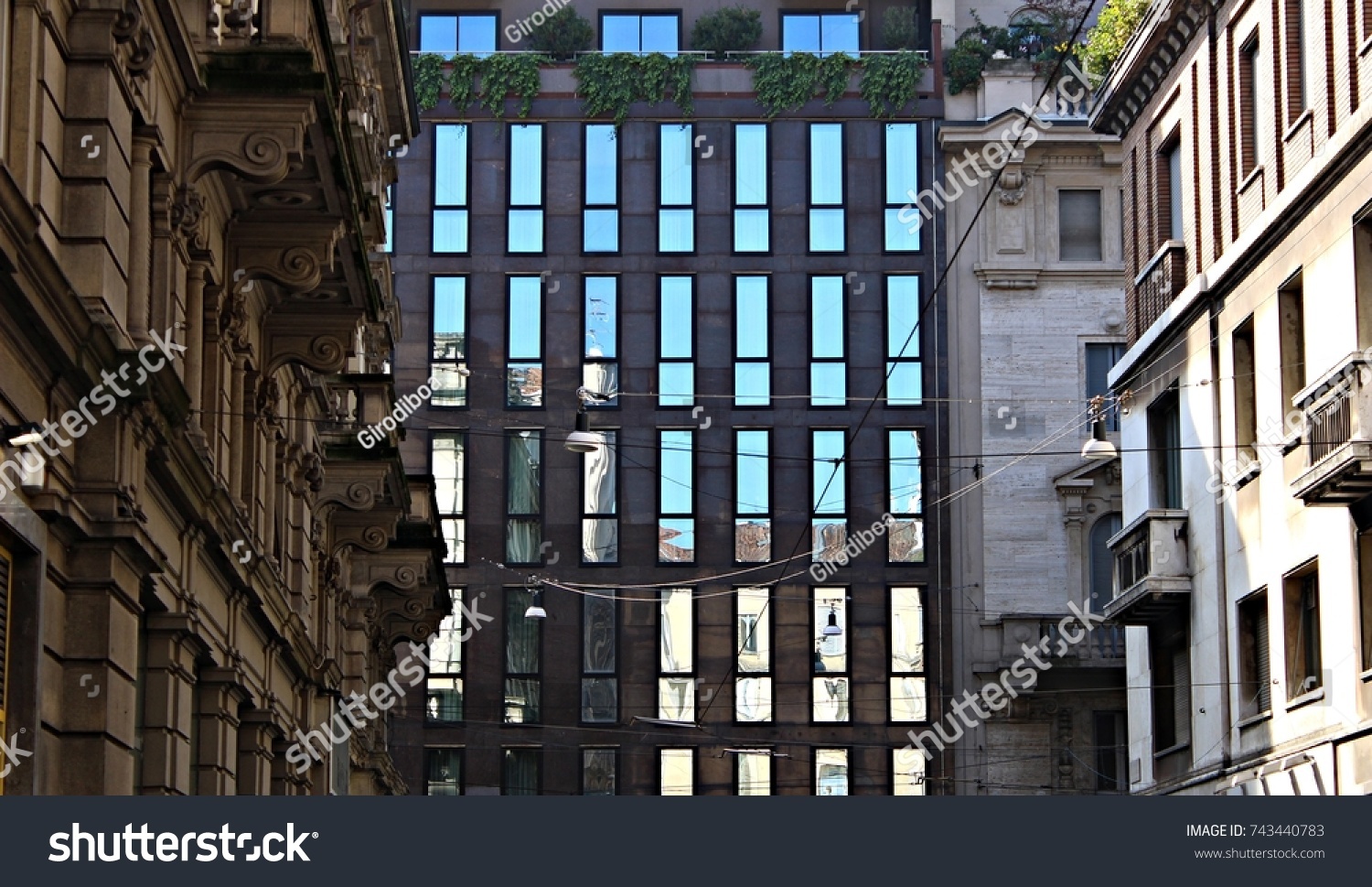Italy, Milano: Reflection of old houses in glass house. #743440783