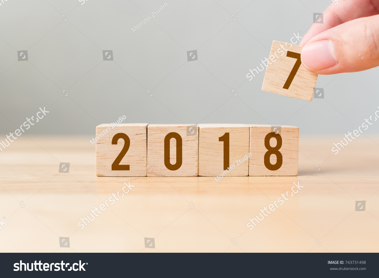 New year 2017 change to 2018 concept, Hand putting wood cube #743731498