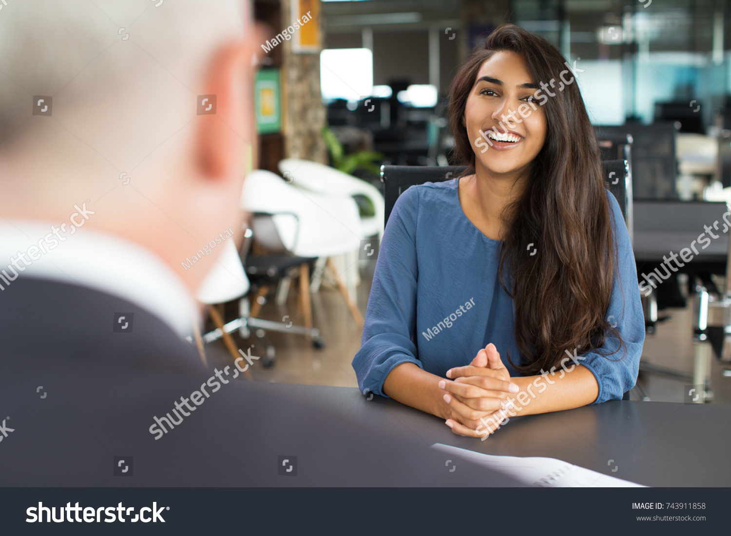 Young female candidate laughing at job interview #743911858