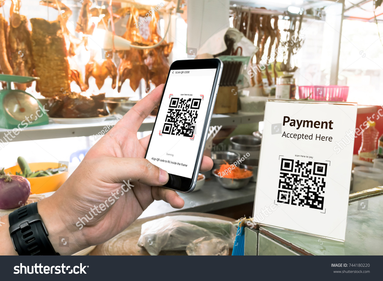Qr code payment , online shopping , cashless technology concept. Restaurant in market accepted digital pay without money , plastic tag on table and hand using mobile phone application to scan qr code. #744180220