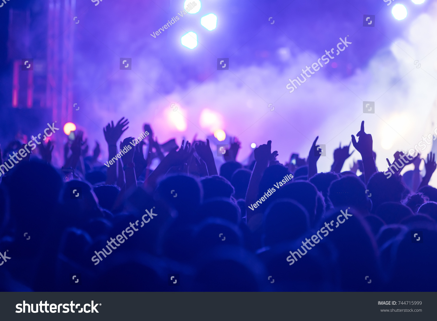 Hand with a smartphone records live music festival, Taking photo of concert stage, live concert, music festival, happy youth, luxury party, landscape exterior #744715999