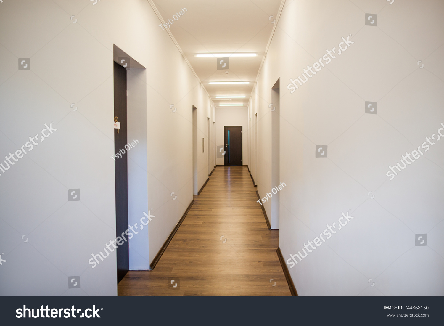 photo of empty corridor with many doors #744868150