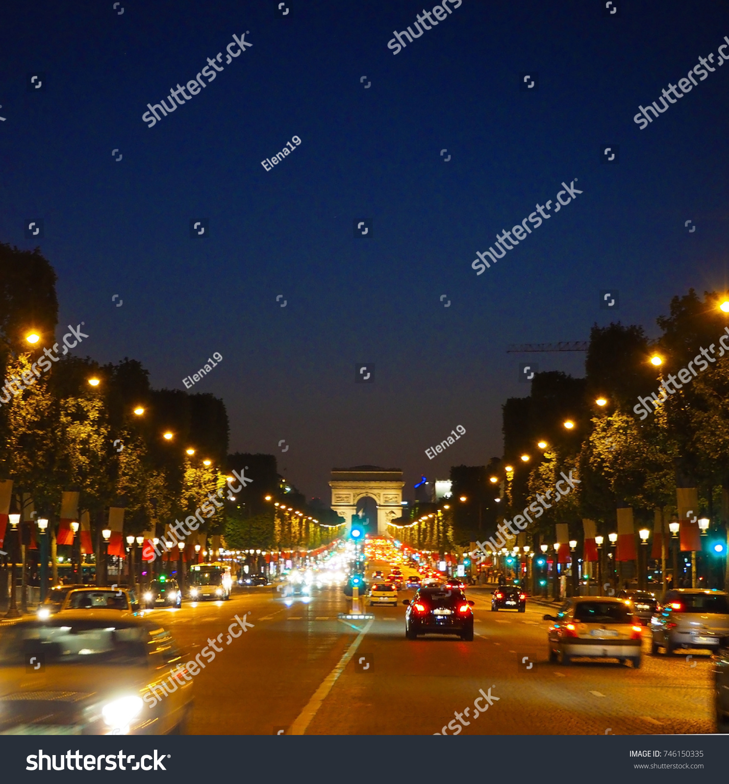 Avenue Champs-Elysees with illumination and triumphal arch on the horizon in Paris, France. Champs Elysees is one of the most famous and famous streets in the world. #746150335